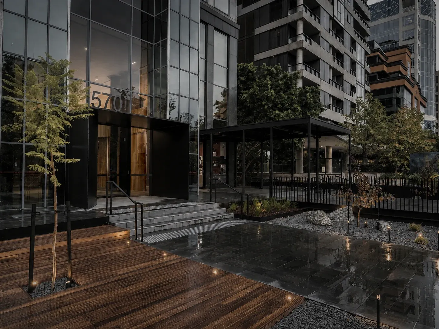 Wet timber and stone forecourt outside 570 St Kilda Road in Melbourne